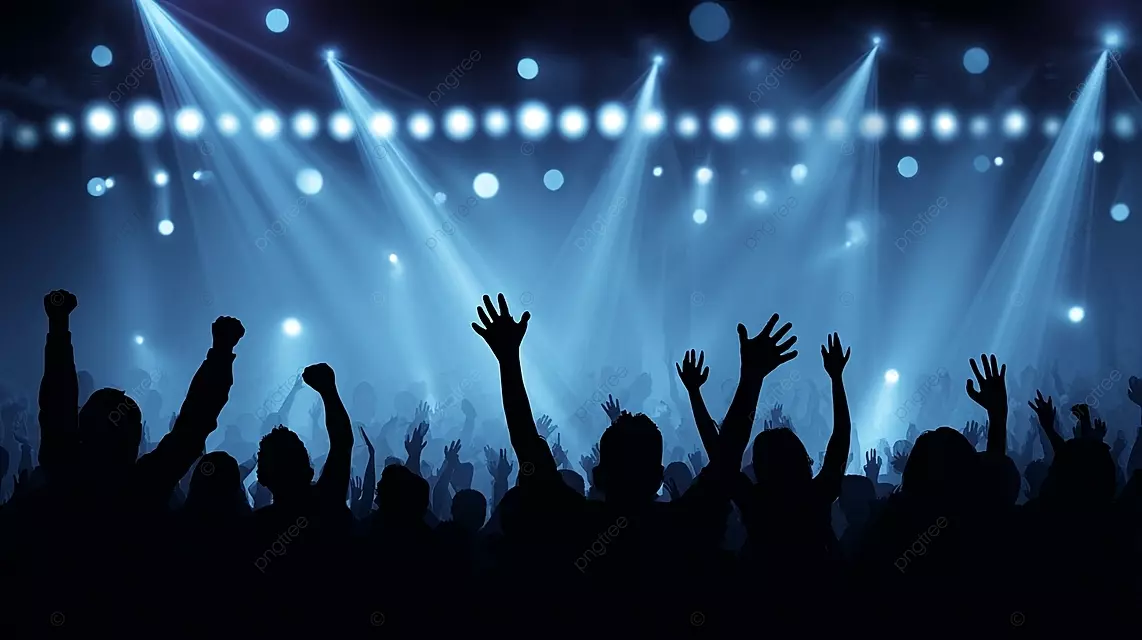 一个人群在充满活力的舞台灯光下的人群以抬高的手臂欢呼